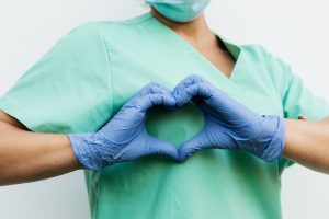 nurse making heart with hands